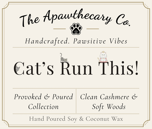Product label for 'Cat's Run This!' from The Apawthecary Co. with cat illustrations and text about handcrafted candles.