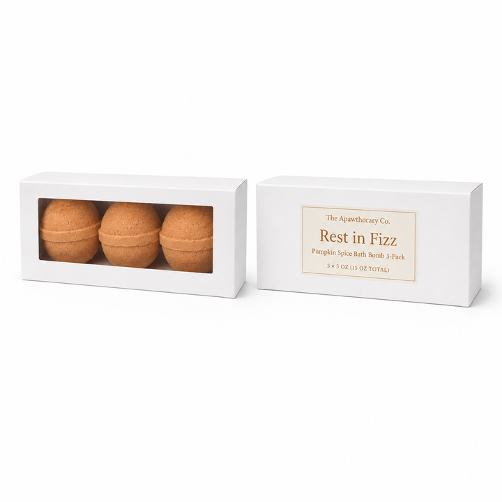 Two white product boxes on a white background: one with a clear window showing three round bath bombs, and one with a cream label reading The Aquaculture Co. Rest in Fizz Pumpkin Spice Bath Bomb 3-Pack.