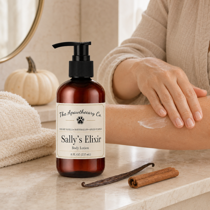 A bottle of The Apothecary Co. 'Sally's Elixir' body lotion stands on a bathroom counter next to a person applying cream to their arm.