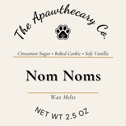 Label for 'Nom Noms' wax melts by The Apawthecary Co. with scents cinnamon sugar, baked cookie, and soft vanilla.
