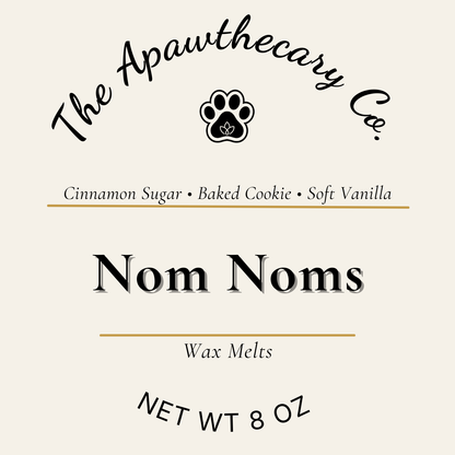 Label for 'Nom Noms' wax melts by The Apawthecary Co. with scents cinnamon sugar, baked cookie, and soft vanilla.