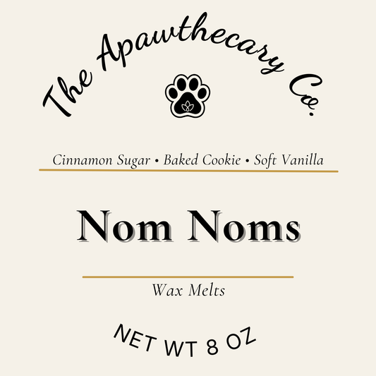 Label for 'Nom Noms' wax melts by The Apawthecary Co. with scents cinnamon sugar, baked cookie, and soft vanilla.