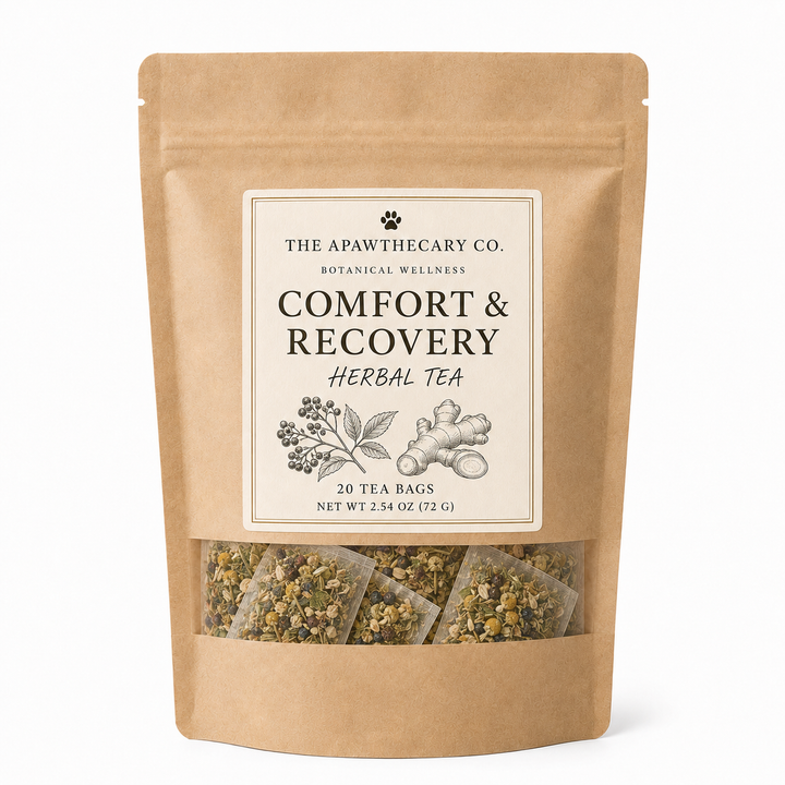 A stand-up kraft paper pouch of The Apawthecary Co. Comfort & Recovery Herbal Tea, featuring a cream label with botanical illustrations and a clear window at the bottom showing the herbal tea bags inside.