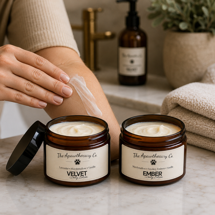 Velvet & Ember - Body Lotion – Lightweight Moisturizer for Dry Skin shown on a marble countertop with hands applying lotion.