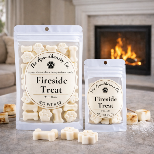 Two packages of 'Fireside Treat' wax melts from The Apawthecary Co. on a surface with a fireplace in the background.