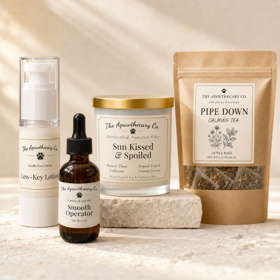 A curated collection of wellness products from The Apothecary Co. arranged on a light stone surface with a matching stone block behind them.