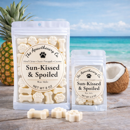 Sun-Kissed & Spoiled wax melts packaging with a pineapple and coconut on a beach background