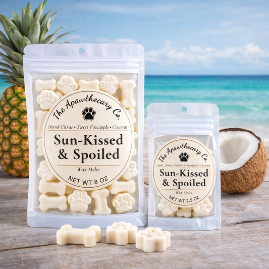 Sun-Kissed & Spoiled wax melts packaging with a pineapple and coconut on a beach background