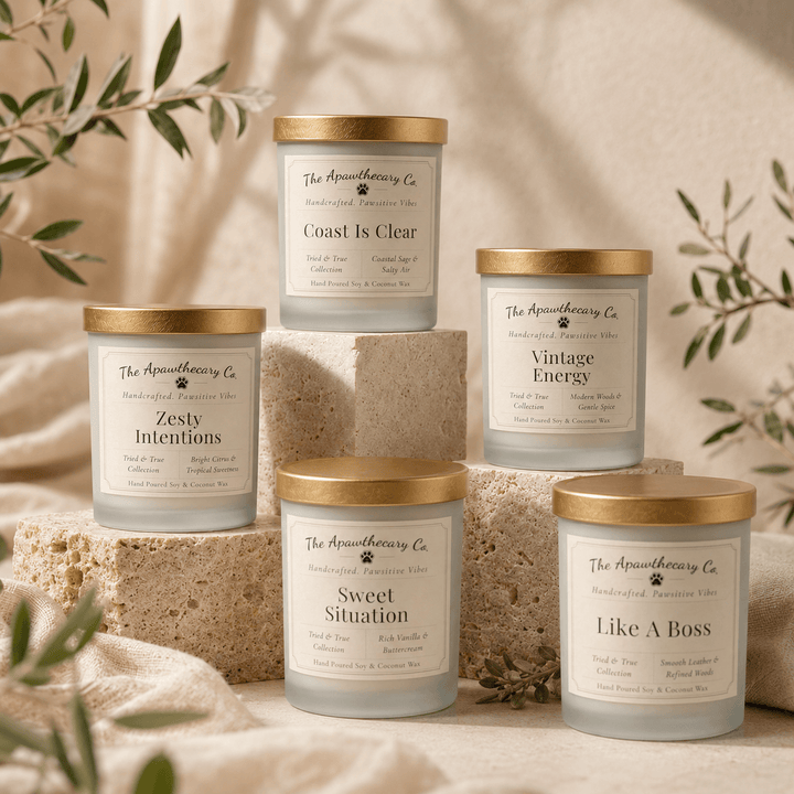 Set of candles with gold lids on a neutral background