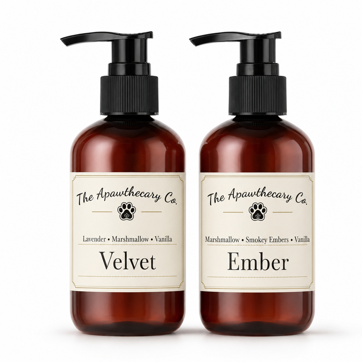 Two amber pump bottles with cream labels from The Apawthecary Co., labeled Velvet and Ember, on a white background.