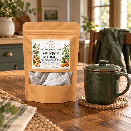My Neck, My Back herbal tea pouch beside a green lidded mug and a jacket on a kitchen chair.