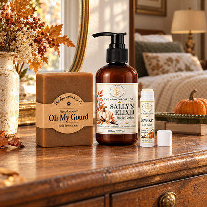 Oh My Gourd soap, Sally’s Elixir Pumpkin Spice body lotion and Low-Key Vanilla & Pumpkin lip balm on a wooden dresser.
