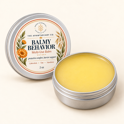 Open Balmy Behavior 2 oz tin showing its pale warm cream-gold balm.