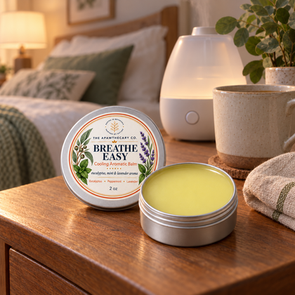 Breathe Easy open aromatic balm tin beside a humidifier in a calm bedroom.