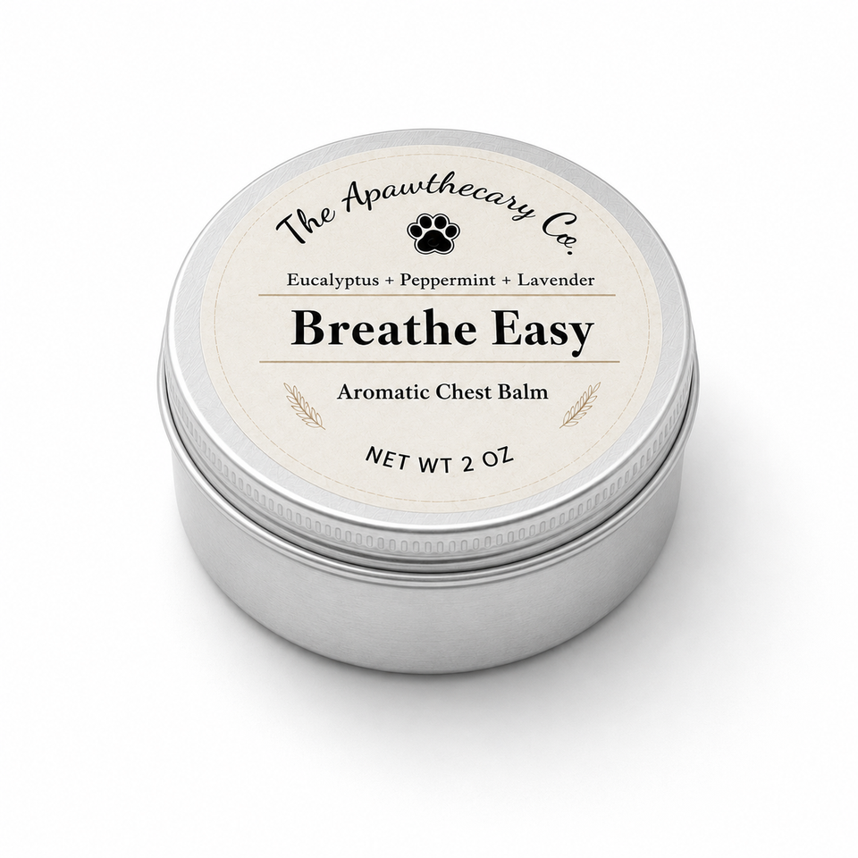 A round silver metal tin of The Apawthecary Co. Breathe Easy Aromatic Chest Balm, featuring a cream-colored label with black text and a small black paw print icon, set against a plain white background.