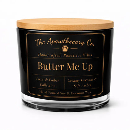 Candle jar labeled 'Butter Me Up' from The Apawthecary Co. on a white background