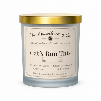 Candle with a label from The Apawthecary Co. on a white background