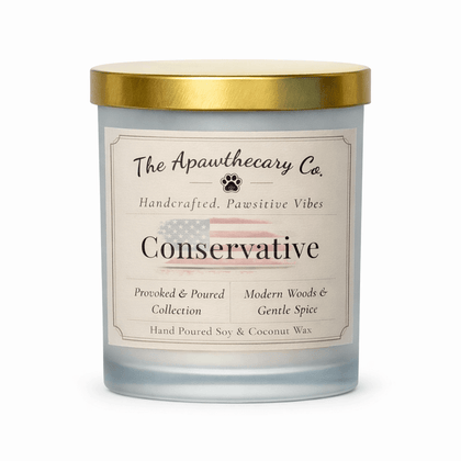 Candle with a label from The Apawthecary Co. on a white background