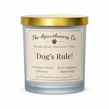 Candle with a gold lid and label from The Apawthecary Co. on a white background