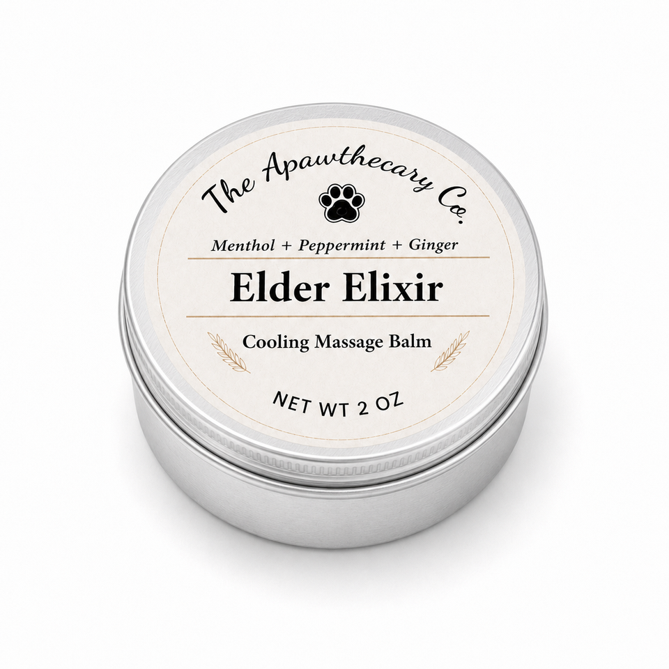 A round silver metal tin of 'Elder Elixir' cooling massage balm by 'The Apawthecary Co.' with a cream-colored label, shown on a clean white background.