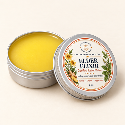 Open Elder Elixir 2 oz tin showing its medium golden-yellow balm with a slight amber cast.