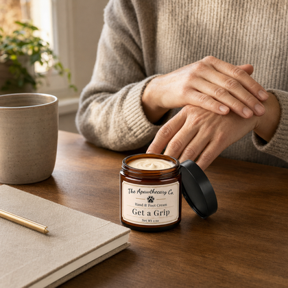 Person resting their hands beside an open jar of Get a Grip hand and foot cream.