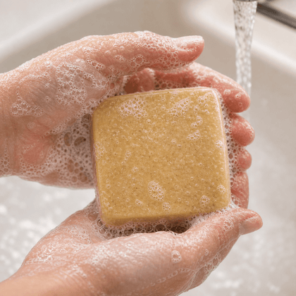 Golden Oat & Honey - Luxury Cold Process Soap - Natural Oat & Honey bar being held in soapy hands.