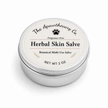 A round silver metal tin of The Apawthecary Co. Herbal Skin Salve, featuring a cream-colored label with black text and a paw print logo, set against a plain white background.