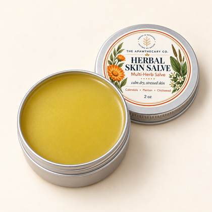 Open Herbal Skin Salve 2 oz tin showing its muted herbal golden-olive balm.