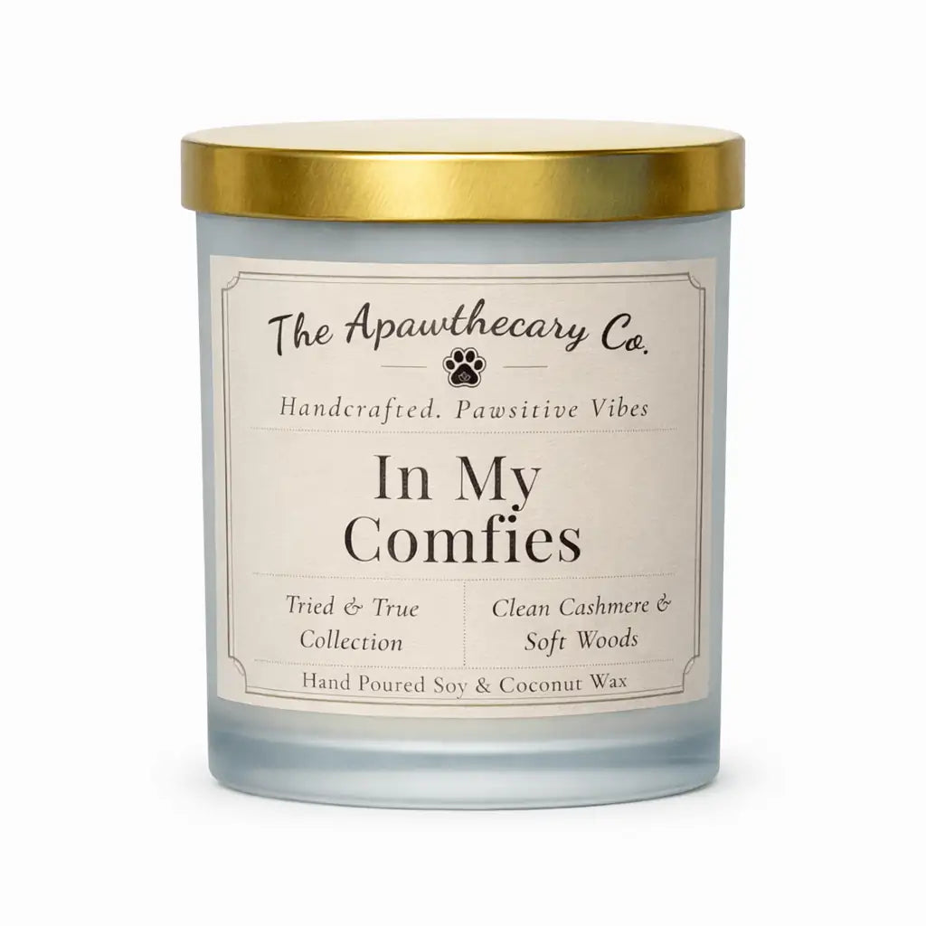 Candle with gold lid and label from The Apawthecary Co. on a white background