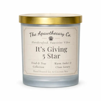 Candle with a gold lid and label from The Apawthecary Co. on a white background