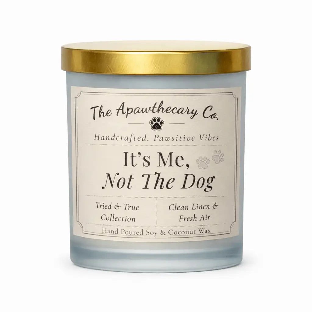 Candle with a gold lid and label from The Apawthecary Co. on a white background