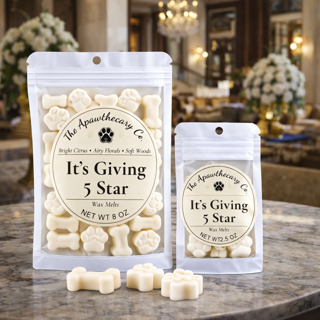 Two packages of 'It's Giving 5 Star' wax melts from The Apawthecary Co. on a marble surface with a blurred background.
