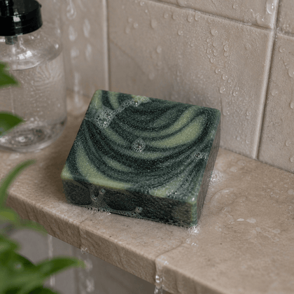 Like A Boss - Luxury Cold Process Soap – Masculine Scented resting on a wet stone surface with bubbles.