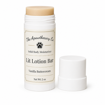 A solid body moisturizer stick by The Apawthecary Co. in Vanilla Buttercream, shown with its white cap removed and placed beside the container on a clean white background.