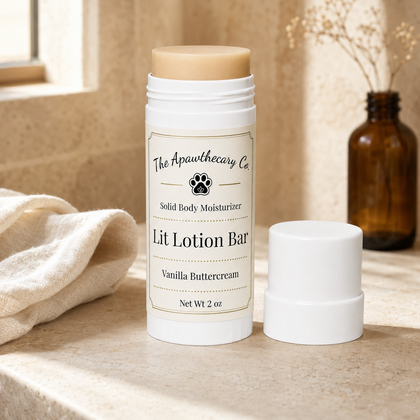 Lit Lotion Bar in a white twist-up tube with its cap beside it on a stone surface.