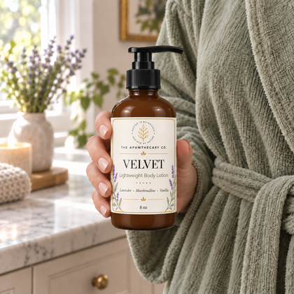 Velvet body lotion held to show bottle size