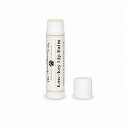 Low-Key Lip Balm tube in vanilla and marshmallow with its cap beside it on a white background.