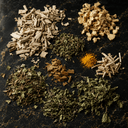 Nine different loose dried herbs and spices, including turmeric powder, arranged in small piles on a dark textured background.