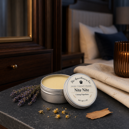 Open tin of Nite Nite aromatic balm beside lavender and wood pieces in a bedroom setting.