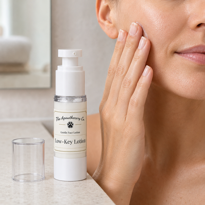 Woman applying Low-Key Lotion to her cheek beside the airless pump bottle.