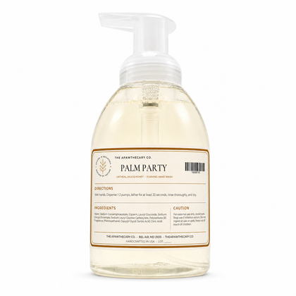 A bottle of The Apothecary Co. Palm Party foaming hand wash, featuring a clear plastic bottle with a white pump dispenser and a cream-colored label with brown borders, set against a plain white background.