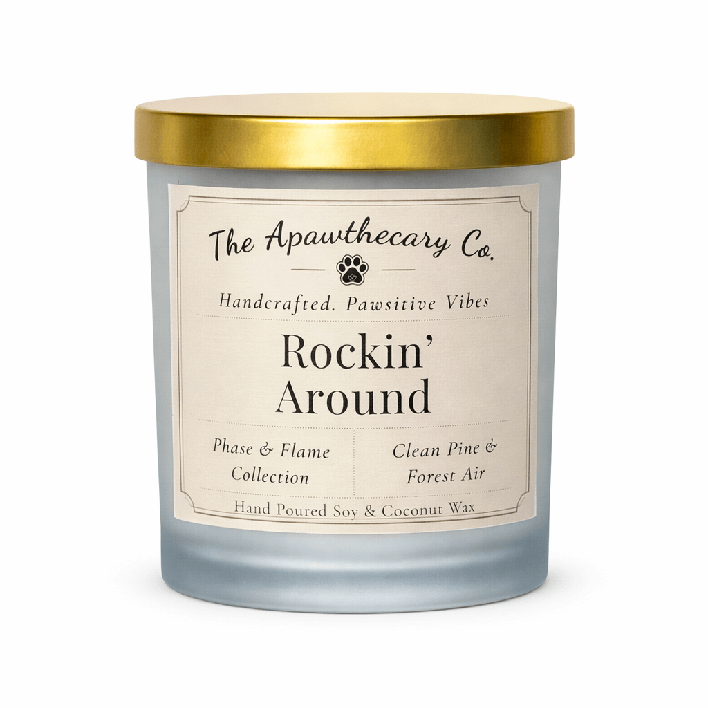 Candle with a gold lid and label from The Apawthecary Co. on a white background