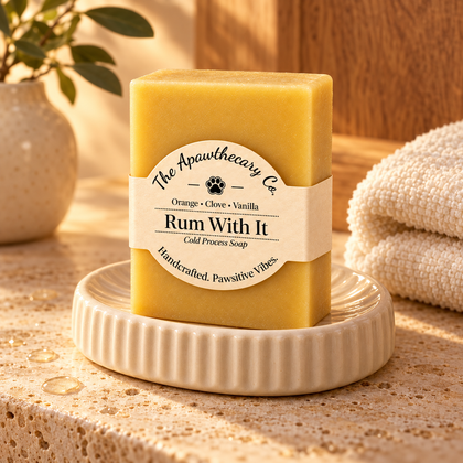 Rum With It soap on a cream ceramic dish in warm light