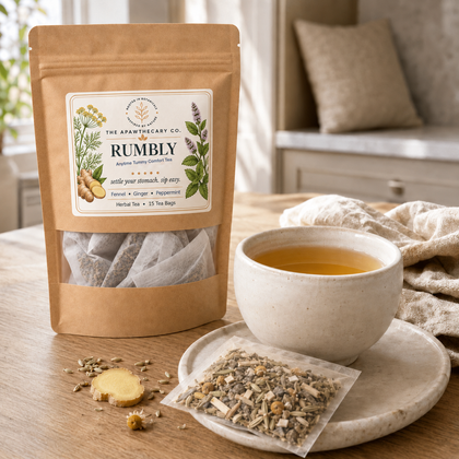 Rumbly 15-bag herbal tea pouch beside a brewed cup and filled tea sachet.