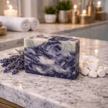 Stormy Nights Cold Process Soap on a marble surface, accompanied by lavender and marshmallows for a calming atmosphere.