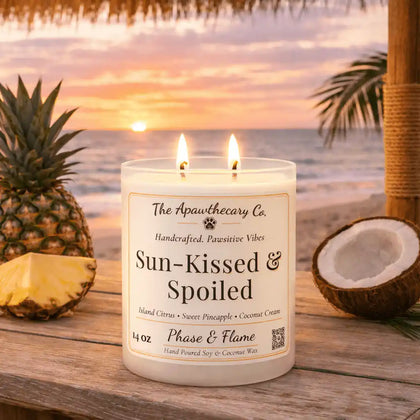Sun-Kissed & Spoiled — Tropical Citrus Coconut & Soft Vanilla Candle displayed on a tropical beach with a pineapple.