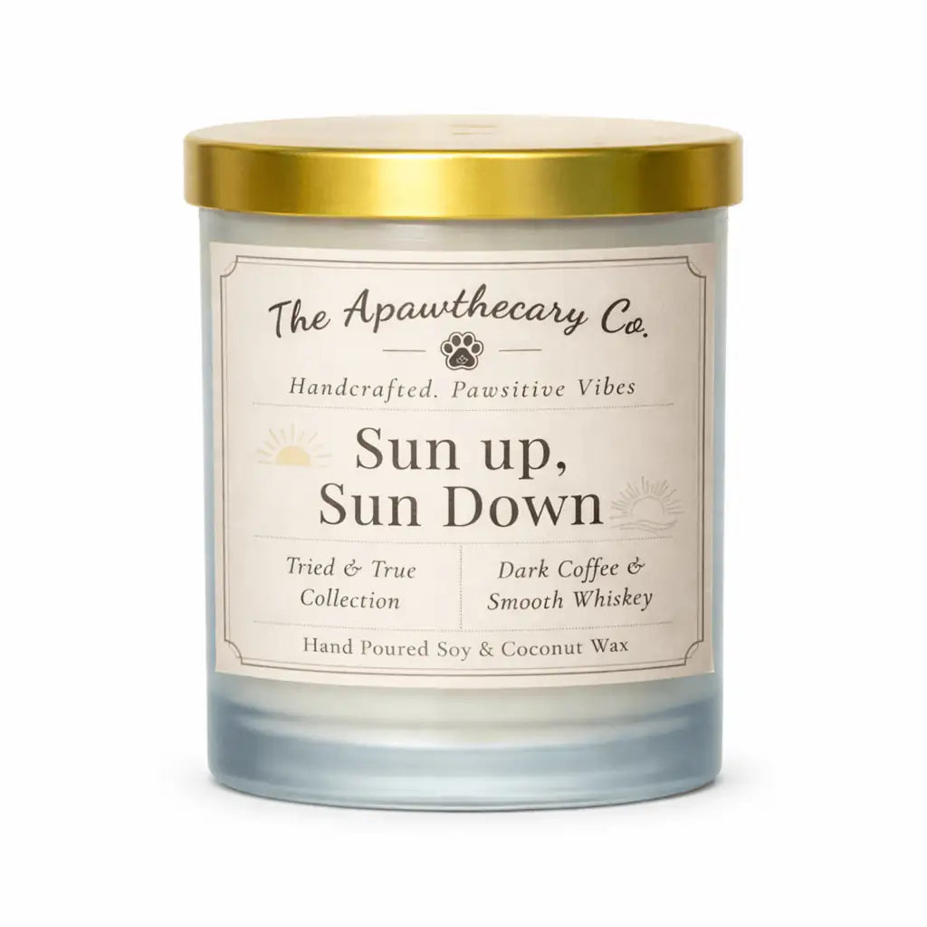 Candle with a gold lid and label from The Apawthecary Co. on a white background