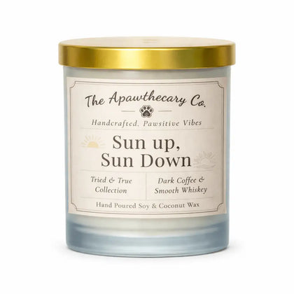 Candle with a gold lid and label from The Apawthecary Co. on a white background