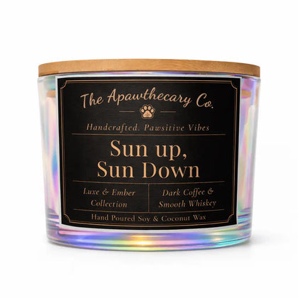 Candle with a label from The Apawthecary Co. on a white background